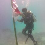 HUT ke-79 TNI, Posal Parimo Gelar Pengibaran Bendera di Bawah Laut